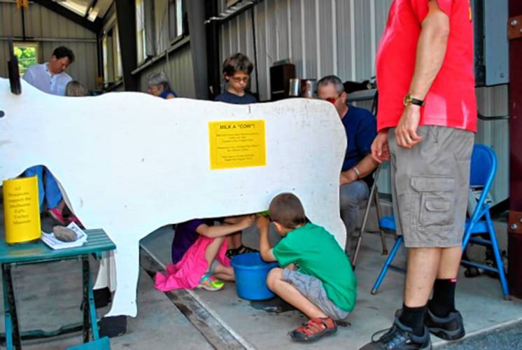 Children “milking” a cardboard cow at previous Trolleyfest celebrations.