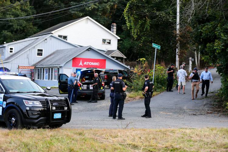 State Police and local law enforcement officers gather along Route 5 near East Street in Easthampton on Friday afternoon as they search for a man who allegedly hit and dragged a state trooper on nearby Interstate 91. A State Police K-9 unit found the Greenfield man after a two-and-half hour search. State Police and local law enforcement officers gather along Route 5 near East Street in Easthampton on Friday afternoon as they search for a man who allegedly hit and dragged a state trooper on nearby Interstate 91. A State Police K-9 unit found the Greenfield man after a two-and-half hour search.