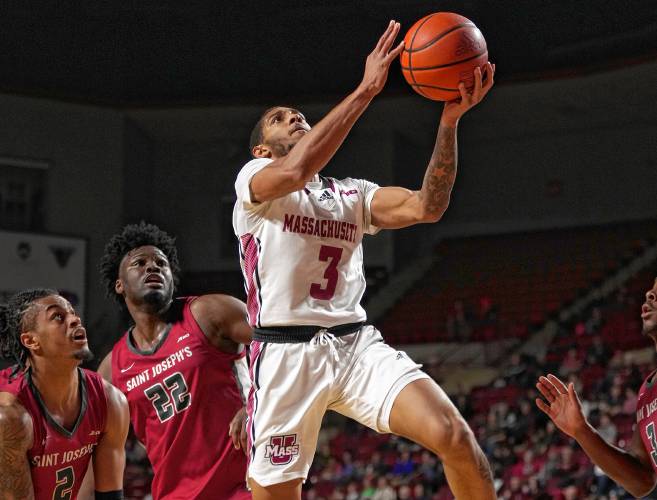 UMass’ Rahsool Diggins (3) drives to the basket against St. Joseph’s during Atlantic 10 Conference action on Tuesday night at the Mullins Center in Amherst.