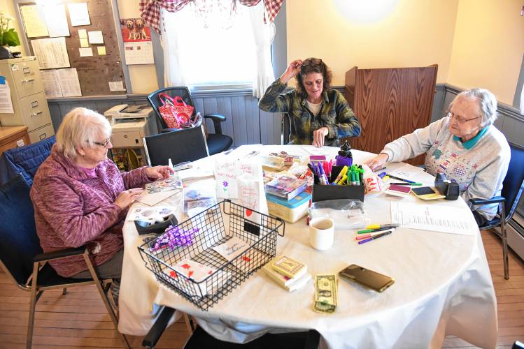 Donna Eddy, Donna Depretto and Phyllis Aldrich make luminaries on Valentine’s Day at the Bernardston Senior Center in honor of late loved ones. The decorated white bags with electric candles in them were set to be displayed in front of the Powers Institute building at dusk. Donna Eddy, Donna Depretto and Phyllis Aldrich make luminaries on Valentine’s Day at the Bernardston Senior Center in honor of late loved ones. The decorated white bags with electric candles in them were set to be displayed in front of the Powers Institute building at dusk.
