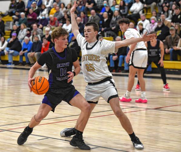 Pioneer’s Will Glazier (25), right, defends Smith Academy’s Cameron Graves (10) during the Panthers’ victory in the PVIAC Class D Tournament on Monday night at Messer Gymnasium in Northfield.