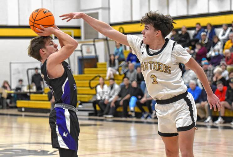 Pioneer’s Kurt Redeker (3), right, tries to block a shot from Smith Academy’s Greg Stone during the Panthers’ victory in the PVIAC Class D Tournament on Monday night at Messer Gymnasium in Northfield.