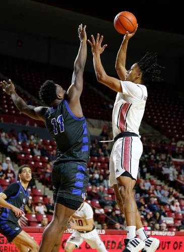 UMass forward Daniel Hankins-Sanford (1), right, puts up a shot in the paint over CCSU forward Abdul Momoh (11) earlier this season at the Mullins Center in Amherst. UMass forward Daniel Hankins-Sanford (1), right, puts up a shot in the paint over CCSU forward Abdul Momoh (11) earlier this season at the Mullins Center in Amherst.