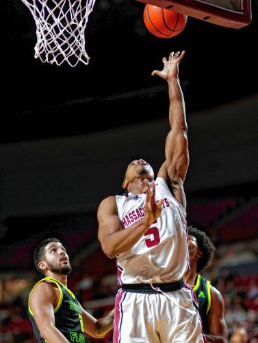UMass guard Keon Thompson (5) puts in a breakaway layup against South Florida in the second half Saturday at the Mullins Center in Amherst. UMass guard Keon Thompson (5) puts in a breakaway layup against South Florida in the second half Saturday at the Mullins Center in Amherst.