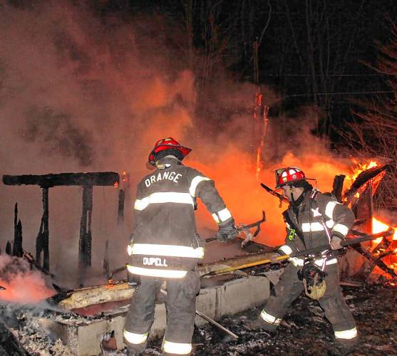 Orange firefighters quell a two-alarm fire on Old South Road on Wednesday morning. Neighbors reported the building had been vacant for years.