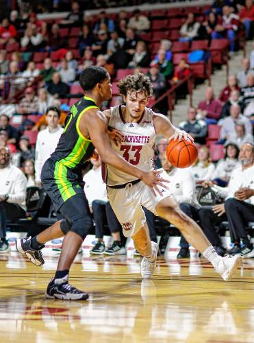 UMass forward Matt Cross (33) drives the ball against South Florida’s Chris Youngblood (3) earlier this season at the Mullins Center in Amherst. UMass forward Matt Cross (33) drives the ball against South Florida’s Chris Youngblood (3) earlier this season at the Mullins Center in Amherst.