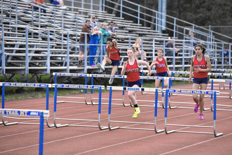 Frontier athletes race in the girls 100-meter hurdles during a meet against Mohawk Trail in Buckland earlier this season. 