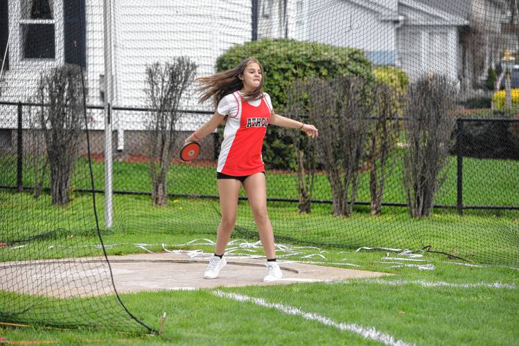 Athol’s Emi Lopez competes in the discus during a meet in Greenfield on Wednesday. 