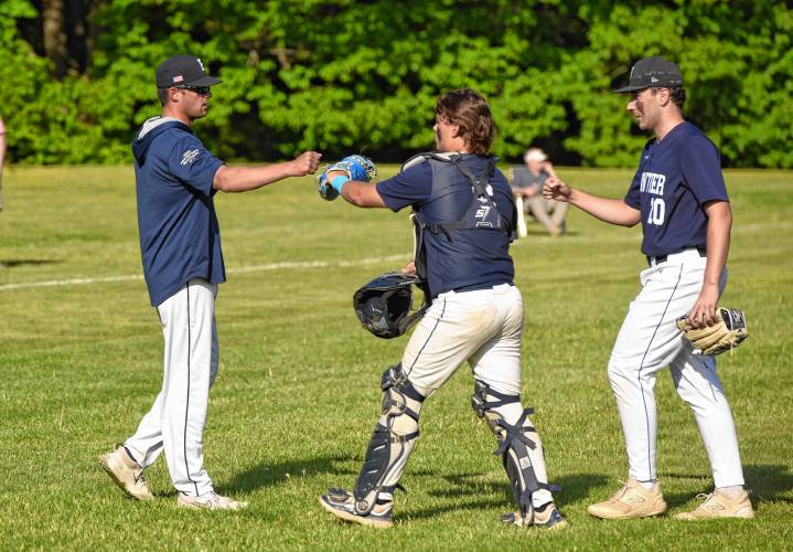 Frontier coach Chris Williams, left, high-fives catcher Kaden James and pitcher Tyler Cusson after an inning against Hampshire during the Western Mass. Class B quarterfinal round on Monday at Earl Tonet Field in Westhampton.
