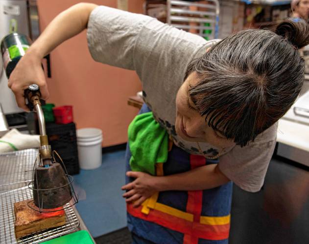 Sarah Seitzm, an employee at The Upper Bend Cafe in Turners Falls, makes an order of maple toast.