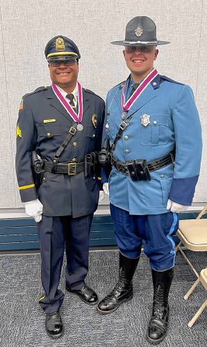 From left, retired Montague Police Sgt. Lee Laster and Massachusetts State Trooper Hunter Ratelle at the Massachusetts State Police headquarters on June 5, where both men were awarded Medals of Valor for their actions during a 2022 house fire in Millers Falls. From left, retired Montague Police Sgt. Lee Laster and Massachusetts State Trooper Hunter Ratelle at the Massachusetts State Police headquarters on June 5, where both men were awarded Medals of Valor for their actions during a 2022 house fire in Millers Falls.