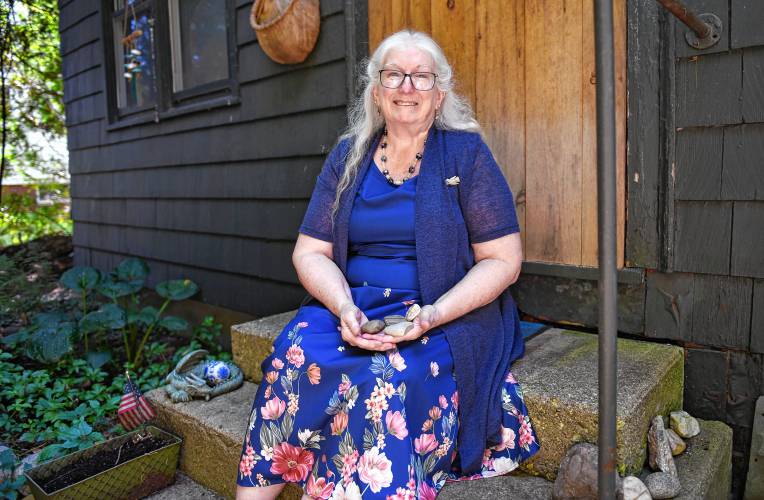 Rev. Linda M. Rhinehart Neas with some of her favorite rocks sitting on her front stoop.