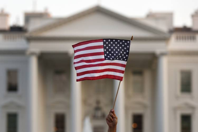 A flag is waved outside the White House, in Washington, D.C. A flag is waved outside the White House, in Washington, D.C.