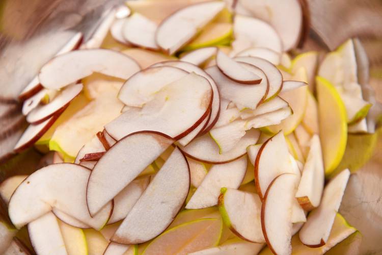 Ella Ingraham makes apple pies by slicing a variety of apples thin, leaving on the skins.