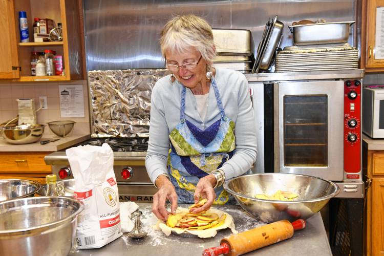 Ella Ingraham making apple pies in the kitchen of the Episcopal Church of Saints James and Andrew in Greenfield.