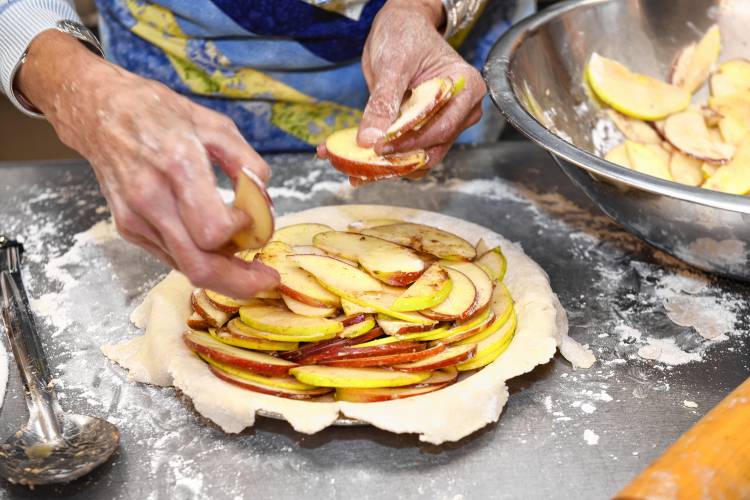 Ella Ingraham makes apple pies by slicing a variety of apples thin and leaving on the skins.