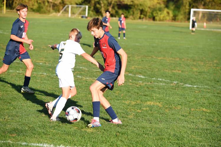Frontier’s Carter Miller looks to make a move while defended by Southwick’s Landon Roberts on Friday at Herlihy Park in Whately. 