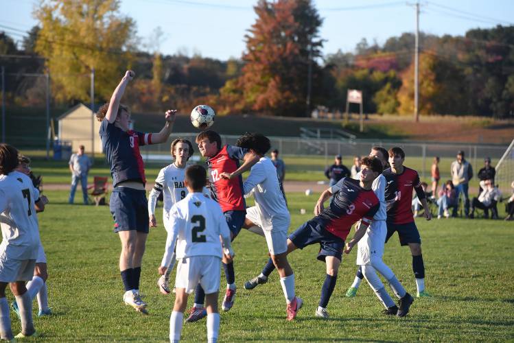 Frontier’s Carter Miller gets his head on the ball in a crowd of players against Southwick on Friday at Herlihy Park in Whately. 