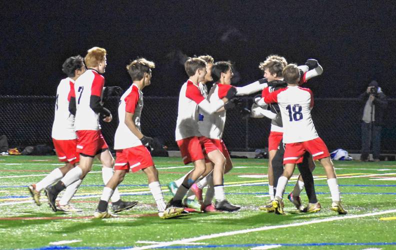 The Frontier boys soccer team swarms goalkeeper Jack Cusson after he stopped the final penalty kick in the Redhawks’ victory over Pittsfield in the MIAA Division 4 Round of 16 on Saturday at Berkshire Community College in Pittsfield. The Frontier boys soccer team swarms goalkeeper Jack Cusson after he stopped the final penalty kick in the Redhawks’ victory over Pittsfield in the MIAA Division 4 Round of 16 on Saturday at Berkshire Community College in Pittsfield.