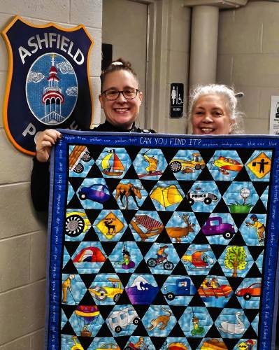 Ashfield Police Chief Beth Bezio and quilter Suzi Kingsley Day hold up a “Local Love” quilt. Ashfield Police received five quilts from 2 Friends Quilting, a quilting studio in Haydenville co-owned by Kingsley Day and her friend Denise LeDuc. The quilters also gave five quilts to the Goshen Police Department and another five to the Williamsburg Police Department. Ashfield Police Chief Beth Bezio and quilter Suzi Kingsley Day hold up a “Local Love” quilt. Ashfield Police received five quilts from 2 Friends Quilting, a quilting studio in Haydenville co-owned by Kingsley Day and her friend Denise LeDuc. The quilters also gave five quilts to the Goshen Police Department and another five to the Williamsburg Police Department.