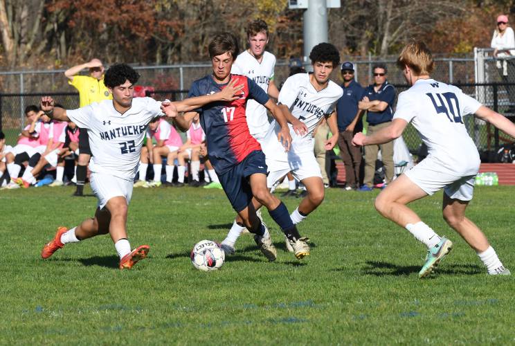 Frontier’s Eric Larsson dribbles through a group of Natucket defenders in South Deerfield during the Redhawks’ MIAA Div. 4 Round of 32 contest last week. Frontier’s Eric Larsson dribbles through a group of Natucket defenders in South Deerfield during the Redhawks’ MIAA Div. 4 Round of 32 contest last week.