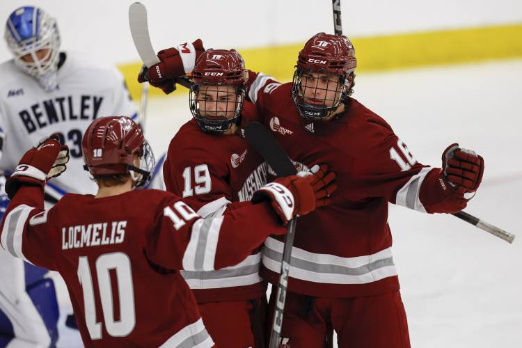 Massachusetts forward Aydar Suniev (16) celebrates with forward Cole O'Hara (19) and forward Dans Locmelis (10) after scoring a goal against Bentley earlier this season in Waltham. Massachusetts forward Aydar Suniev (16) celebrates with forward Cole O'Hara (19) and forward Dans Locmelis (10) after scoring a goal against Bentley earlier this season in Waltham.