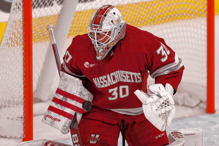 Massachusetts goalie Michael Hrabal (30) stops the puck during the first period of an NCAA hockey game against Bentley on Saturday, Oct. 5, 2024, in Waltham, Mass. (AP Photo/Greg M. Cooper)