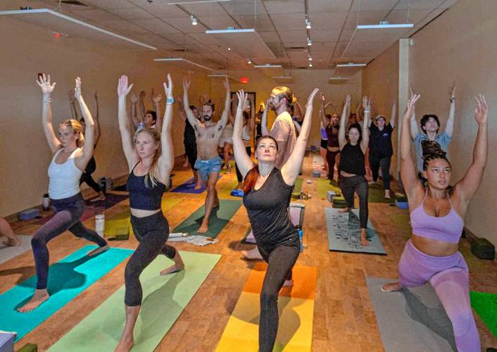 Participants in a yoga class at Resonance Hot Yoga and Massage in Amherst.