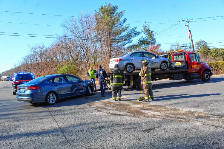 Members of the Bernardston Police and Fire departments clear debris from Route 10 after a two-car collision sent an elderly man to Baystate Franklin Medical Center in Greenfield on Monday. Members of the Bernardston Police and Fire departments clear debris from Route 10 after a two-car collision sent an elderly man to Baystate Franklin Medical Center in Greenfield on Monday.
