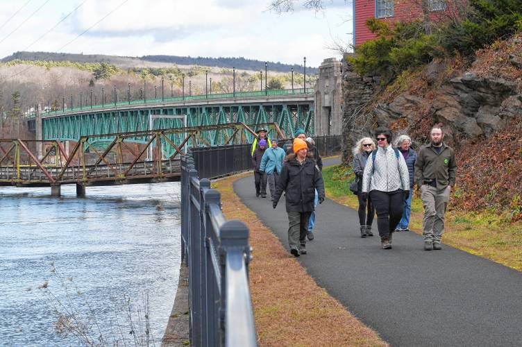 Janel Nockleby, visitor service supervisor at the Great Falls Discovery Center, left, leads a “Go Green on Black Friday” hike along the canalside bike path in Turners Falls on Friday. Janel Nockleby, visitor service supervisor at the Great Falls Discovery Center, left, leads a “Go Green on Black Friday” hike along the canalside bike path in Turners Falls on Friday.