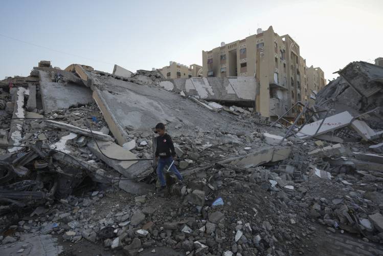 A Palestinian boy walks amongst rubble of destroyed buildings at a neighbourhood in Khan Younis, Gaza Strip, Sunday, Dec. 1, 2024. A Palestinian boy walks amongst rubble of destroyed buildings at a neighbourhood in Khan Younis, Gaza Strip, Sunday, Dec. 1, 2024.