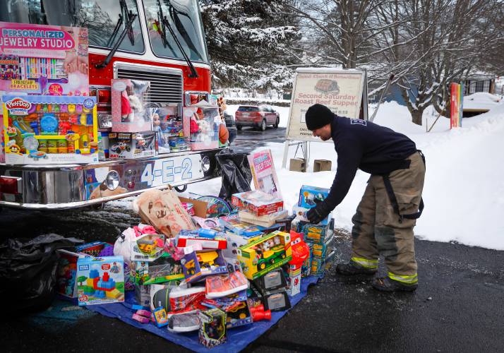 Jake Tokarz places a donation on the pile during the 2019 Bernardston Police and Fire departments’ annual toy drive at the United Church of Bernardston. Jake Tokarz places a donation on the pile during the 2019 Bernardston Police and Fire departments’ annual toy drive at the United Church of Bernardston.