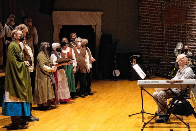Performers, under the direction of Greenfield resident Fred Momaney, right, rehearse for their production of “Welcome Yule: A Midwinter Celebration” at the Shea Theater Arts Center in Turners Falls.